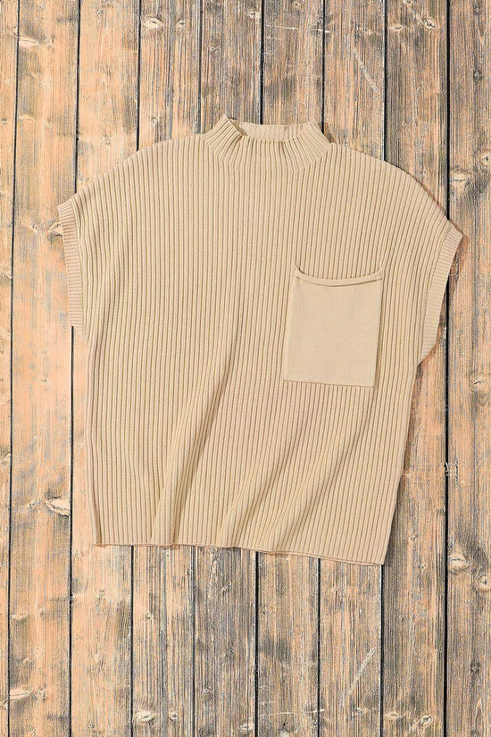 Oatmeal ribbed knit sweater dress with short sleeves and chest pocket, laid flat on wooden background for product display.