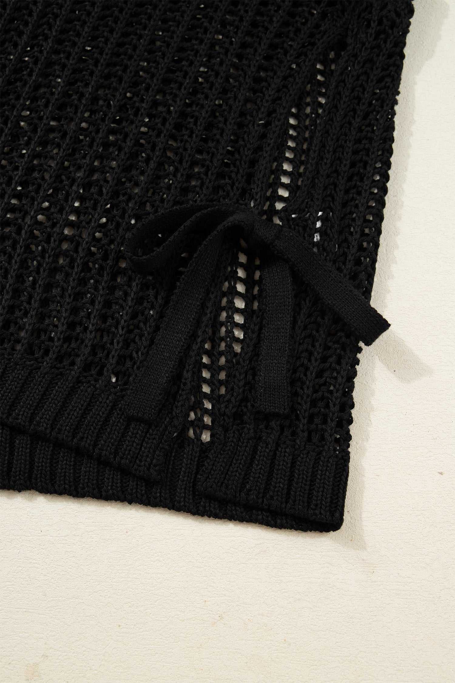 Close-up of black Plus Size Bow Tie Open‑Knit Jumper for Women showing detailed bow tie and breathable knit fabric.