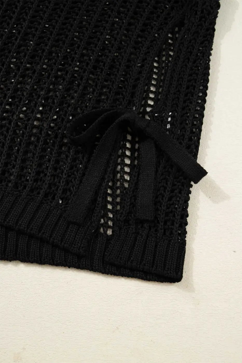Close-up of black Plus Size Bow Tie Open‑Knit Jumper for Women showing detailed bow tie and breathable knit fabric.