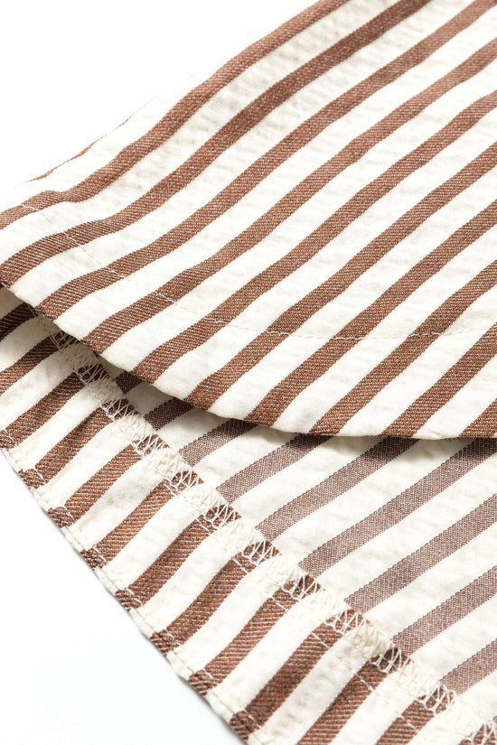 Hem detail of brown striped midi shirt dress with visible stitching, highlighting breathable fabric and casual finish.