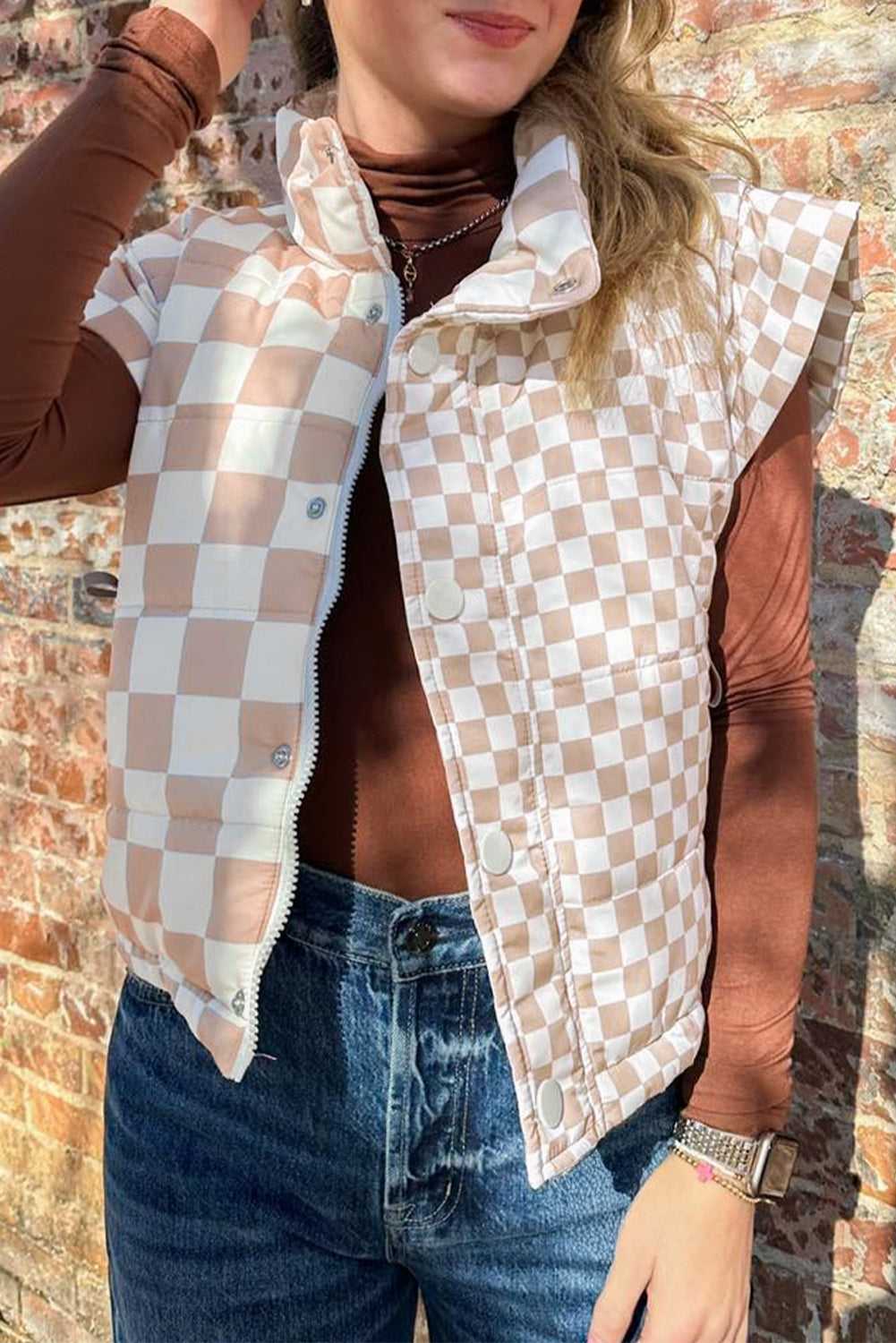 Ladies khaki plaid quilted gilet styled with brown turtleneck and jeans, featuring button and zip closure for versatile winter layering.