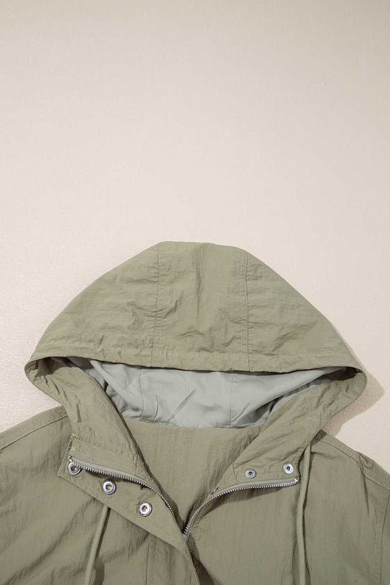 Close-up of adjustable hood on Cropped Hooded Utility Jacket in laurel green, emphasizing comfort and weather-ready design.
