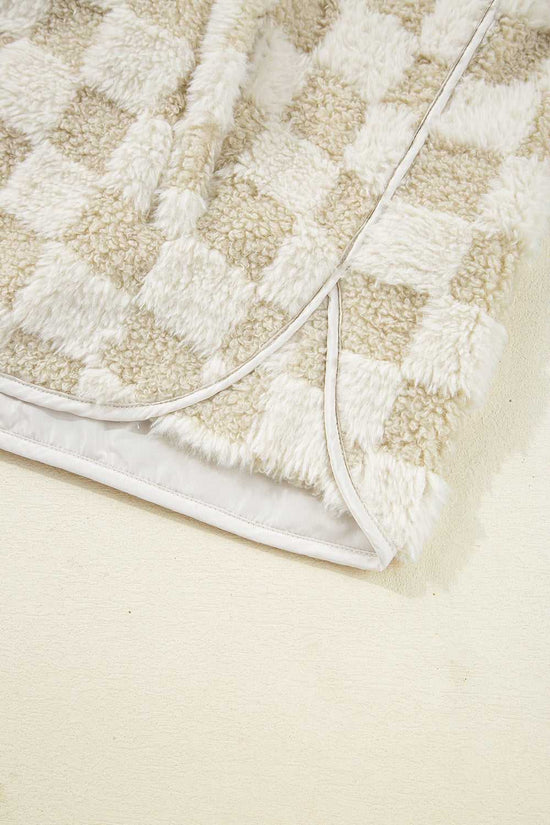 Close-up of a textured Sherpa Fleece Vest with a geometric pattern on a light beige background