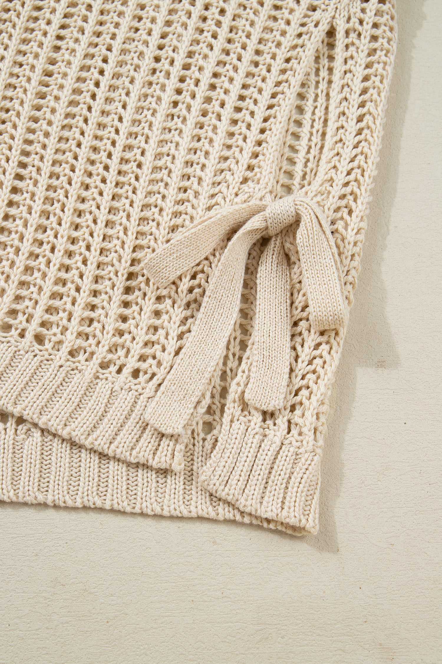 Close-up of beige Plus Size Bow Tie Open‑Knit Jumper for Women showing side bow detail and soft open-knit texture.