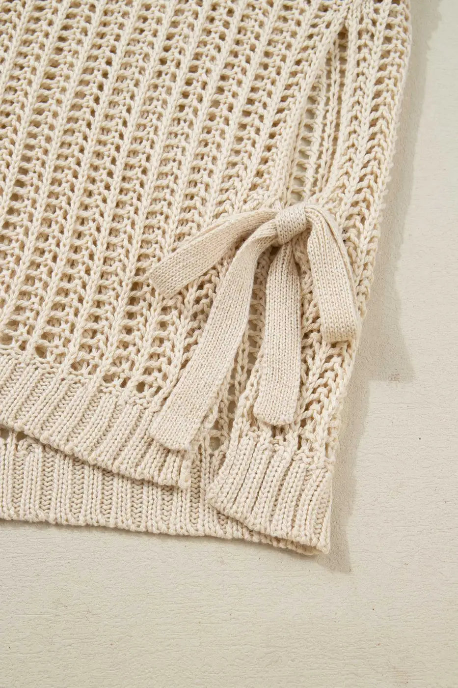 Close-up of beige Plus Size Bow Tie Open‑Knit Jumper for Women showing side bow detail and soft open-knit texture.