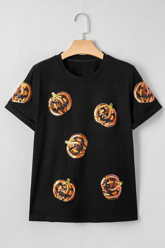 Sequin Pumpkin Face Halloween T-Shirt on a hanger against a gray background