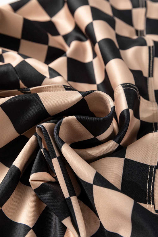 Detailed fabric view of Checkered Skinny Leggings showing soft, flexible material with black and beige checkerboard pattern.