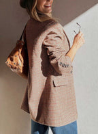 Back view of Ladies Brown Houndstooth Fitted Blazer paired with a brown leather bag, highlighting tailored fit and button details.