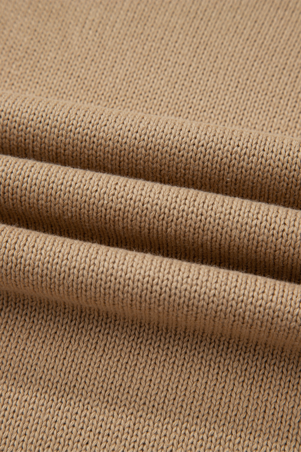 Close-up of beige fabric with a textured pattern