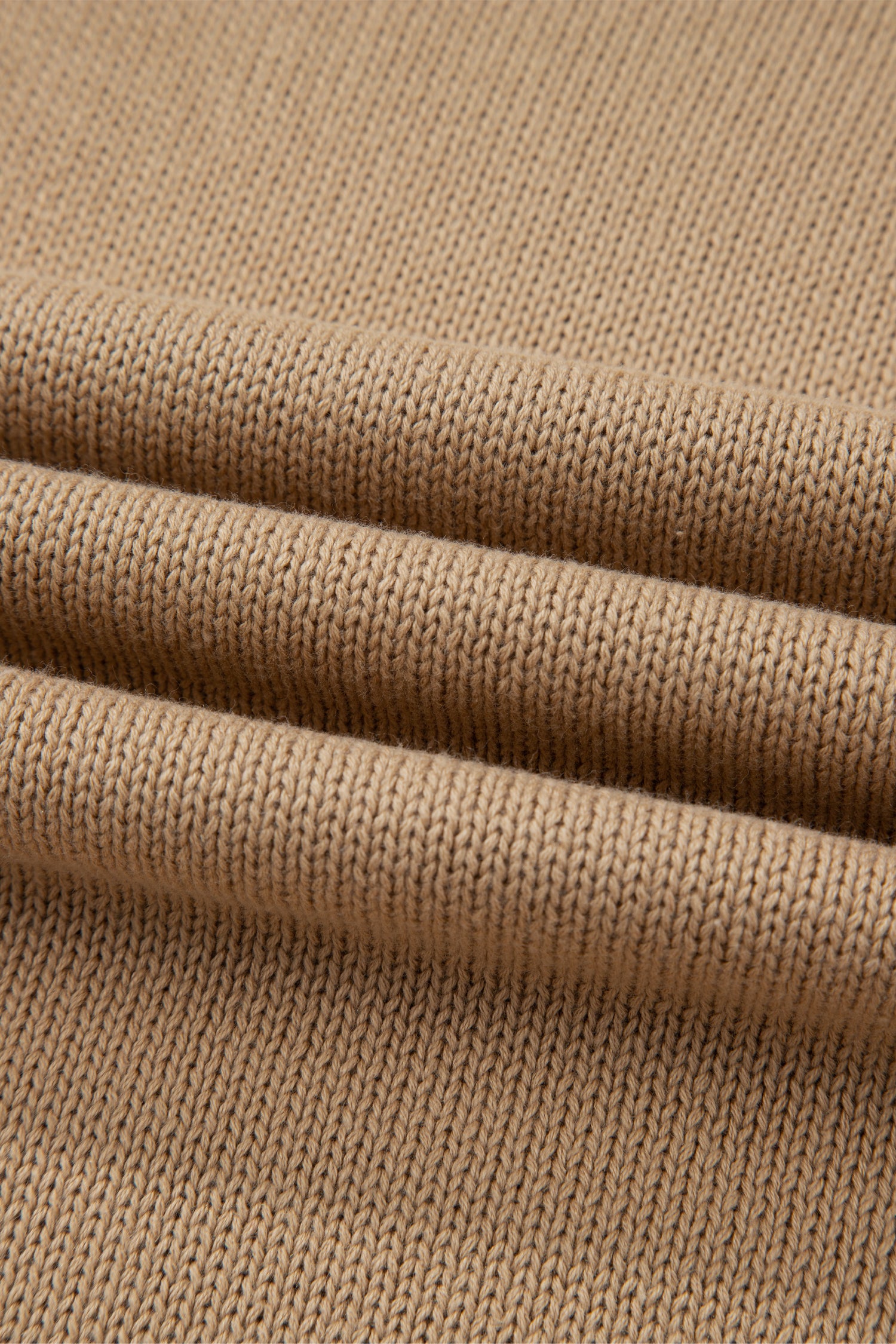 Close-up of beige fabric with a textured pattern