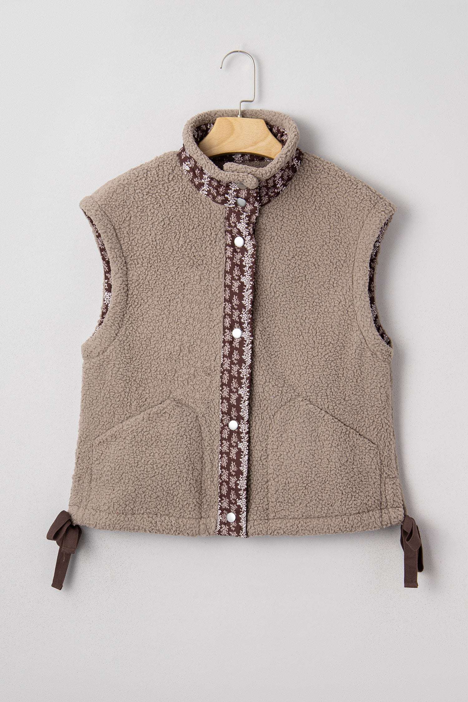 Flat lay of Women's Country Borg Fleece Gilet Winter Vest FashionFitz on hanger, featuring khaki sherpa fleece and floral button placket.