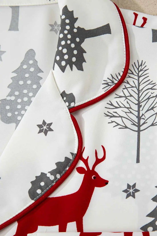 Detailed view of collar on Ladies White Christmas Print Velvet Trim Pyjamas featuring red piping and holiday-themed print for stylish loungewear.