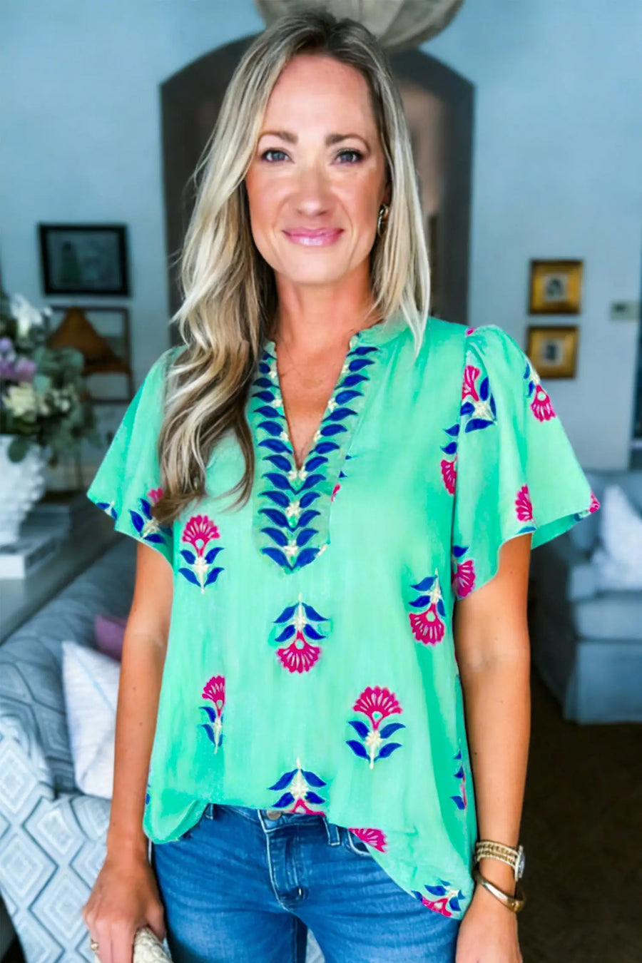 Floral V-neck blouse styled with linen trousers — summer holiday look