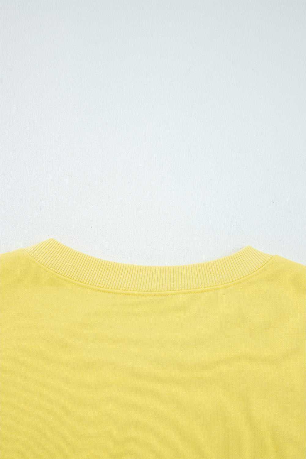 Rear neckline detail of yellow Drop Crop Wide-Leg Pants Set, showcasing ribbed collar for added comfort and durability.
