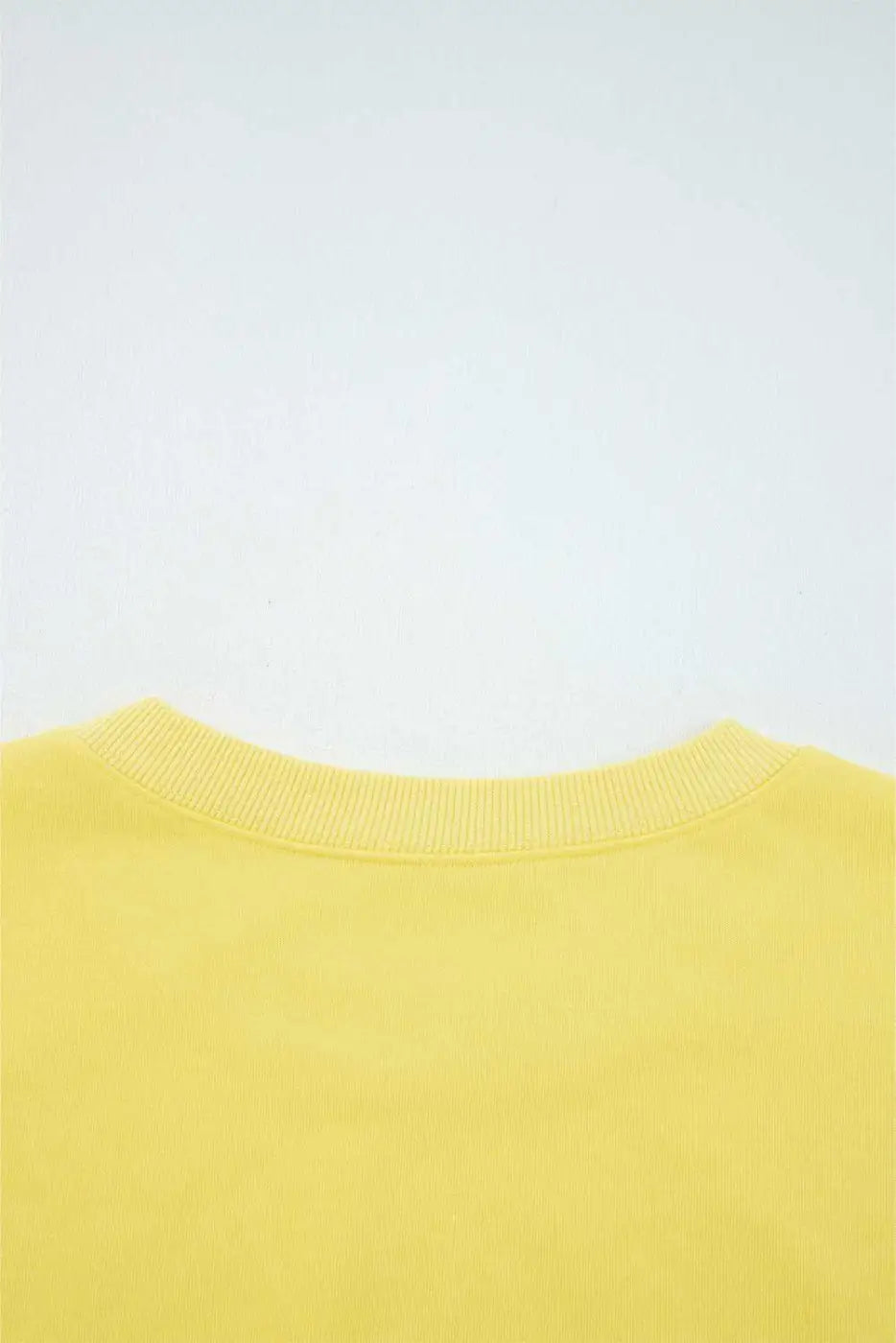 Rear neckline detail of yellow Drop Crop Wide-Leg Pants Set, showcasing ribbed collar for added comfort and durability.