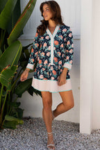 Model wearing Ladies Blue Floral Shift Mini Dress with striped accents and floral design, styled for casual spring fashion with a boho flair.