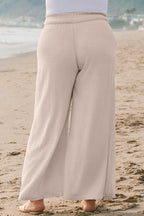 Back view of Wide Leg Plus Linen Pants in beige, showcasing relaxed fit and breathable fabric. Ideal plus size summer trousers for daily wear.