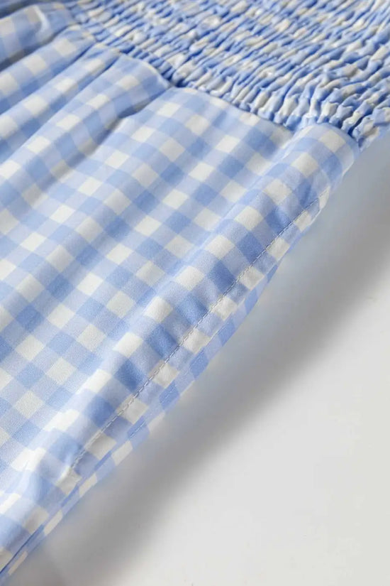 Close-up of elastic waistband on plaid wide leg trousers