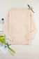 Eyelet elegance drop: pale pink knitted sweater with textured pattern and ribbed cuffs