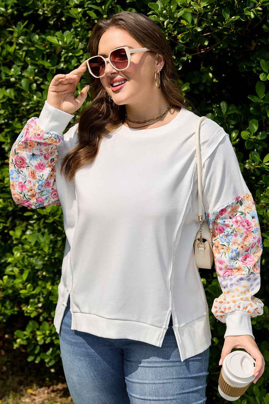 Plus size floral sleeve sweatshirt with colorblock patchwork sleeves in pink, blue, and orange tones. Styled for a casual fall look.