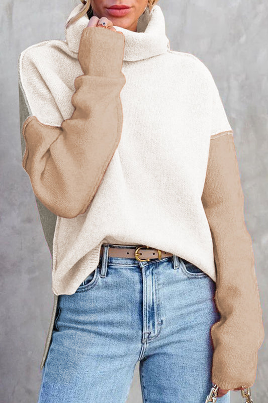 Person wearing a Soft Turtle-Neck Knit Jumper, paired with blue jeans on a gray background.