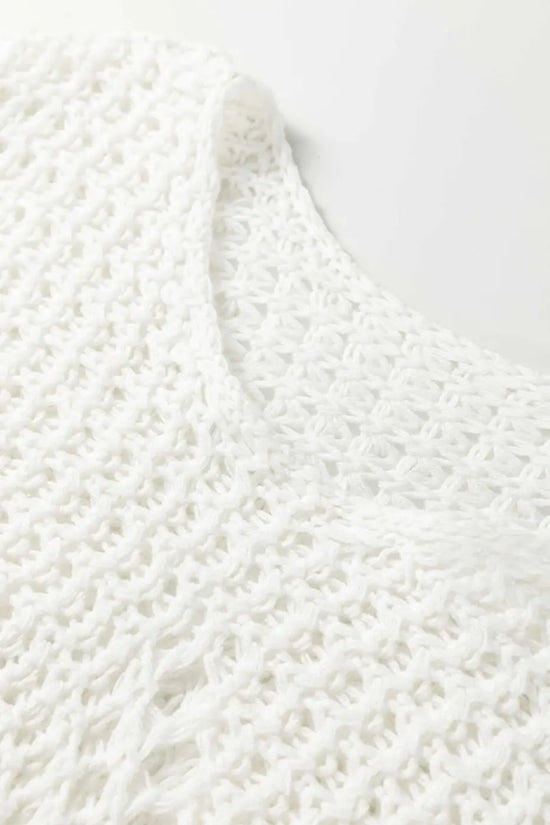 Detailed close-up of white wide sleeve hollow knit jumper neckline and texture, emphasizing its soft, breathable knit fabric.