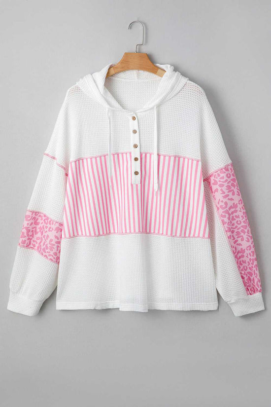 Flat lay of Curve Pink Leopard Stripe Waffle Hoodie for Women on hanger, displaying pink stripe and leopard patchwork on white waffle knit fabric.