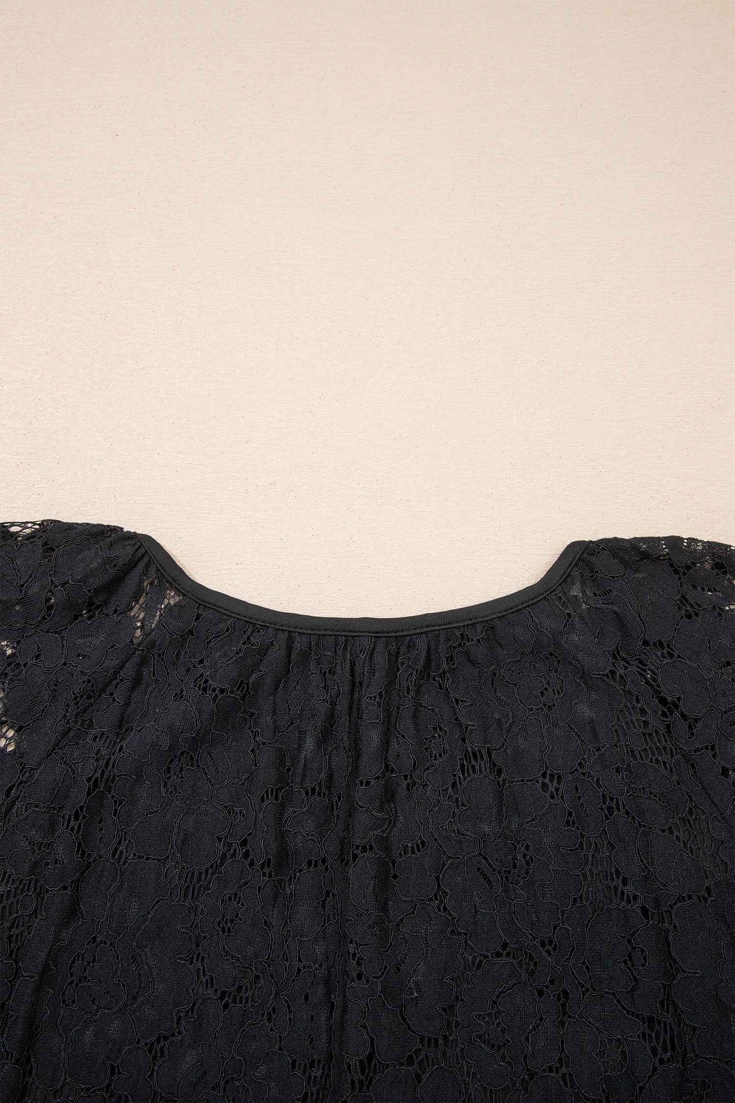 Back neckline detail of the Black Lace Overlay Maxi Sundress showing gathered lace design and smooth finish for a relaxed summer look.