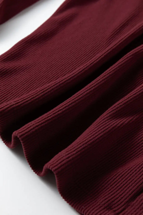 Hem detail of brown ribbed long sleeve crop top showing ribbed texture and clean stitching. Great for autumn and winter styling.