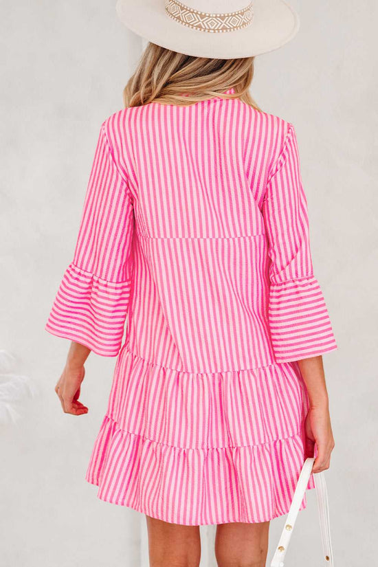Back view of pink striped tiered flowy mini dress women