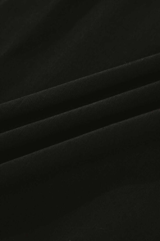 Fabric texture close-up of Monochrome Knit Dress - Cozy & Stylish | FashionFitz highlighting soft black material ideal for fall comfort.