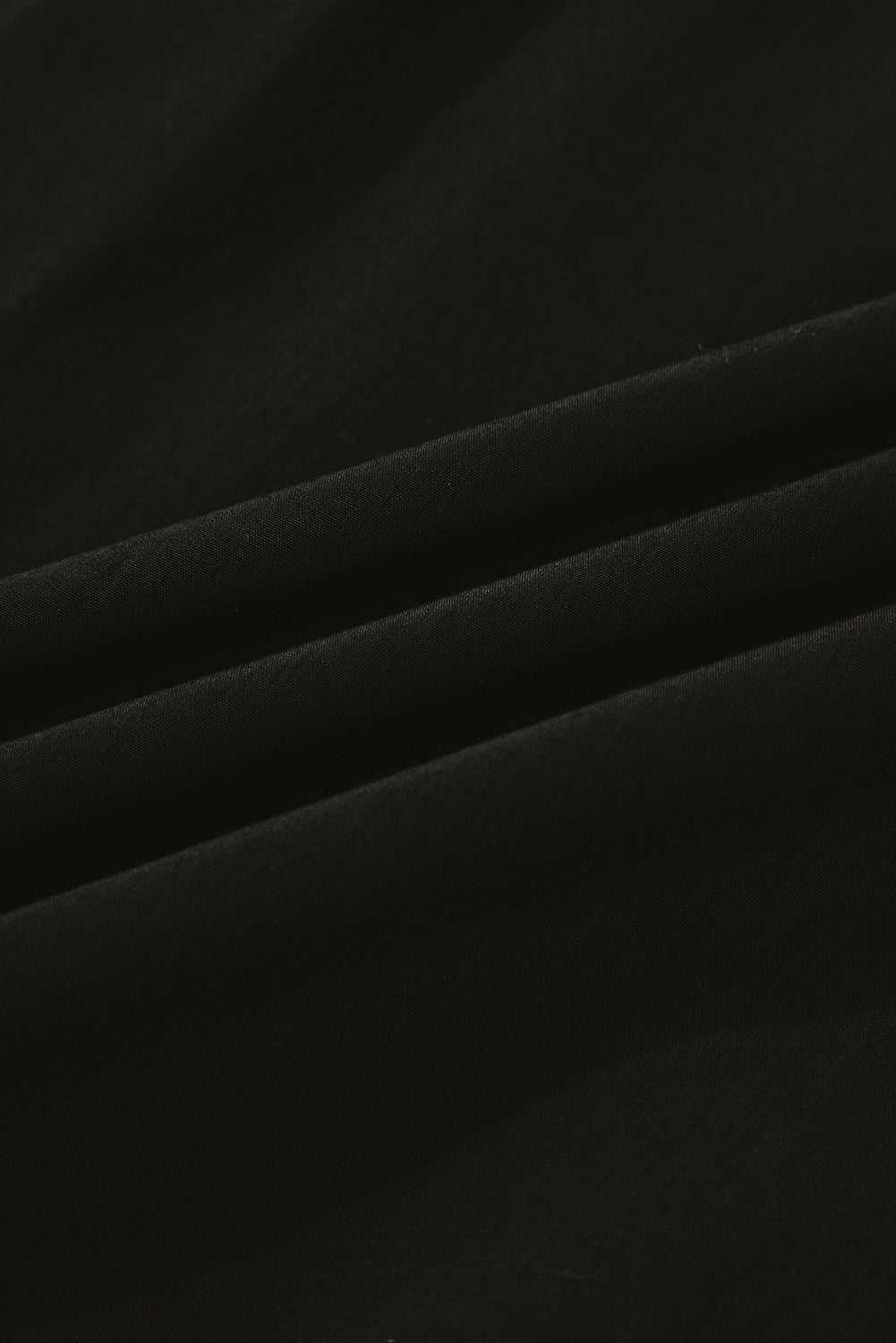 Fabric texture close-up of Monochrome Knit Dress - Cozy & Stylish | FashionFitz highlighting soft black material ideal for fall comfort.