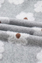 Folded fabric detail of FashionFitz Oversized Grey Floral Knit Jumper showing soft knit texture and white floral pattern with brown centers.