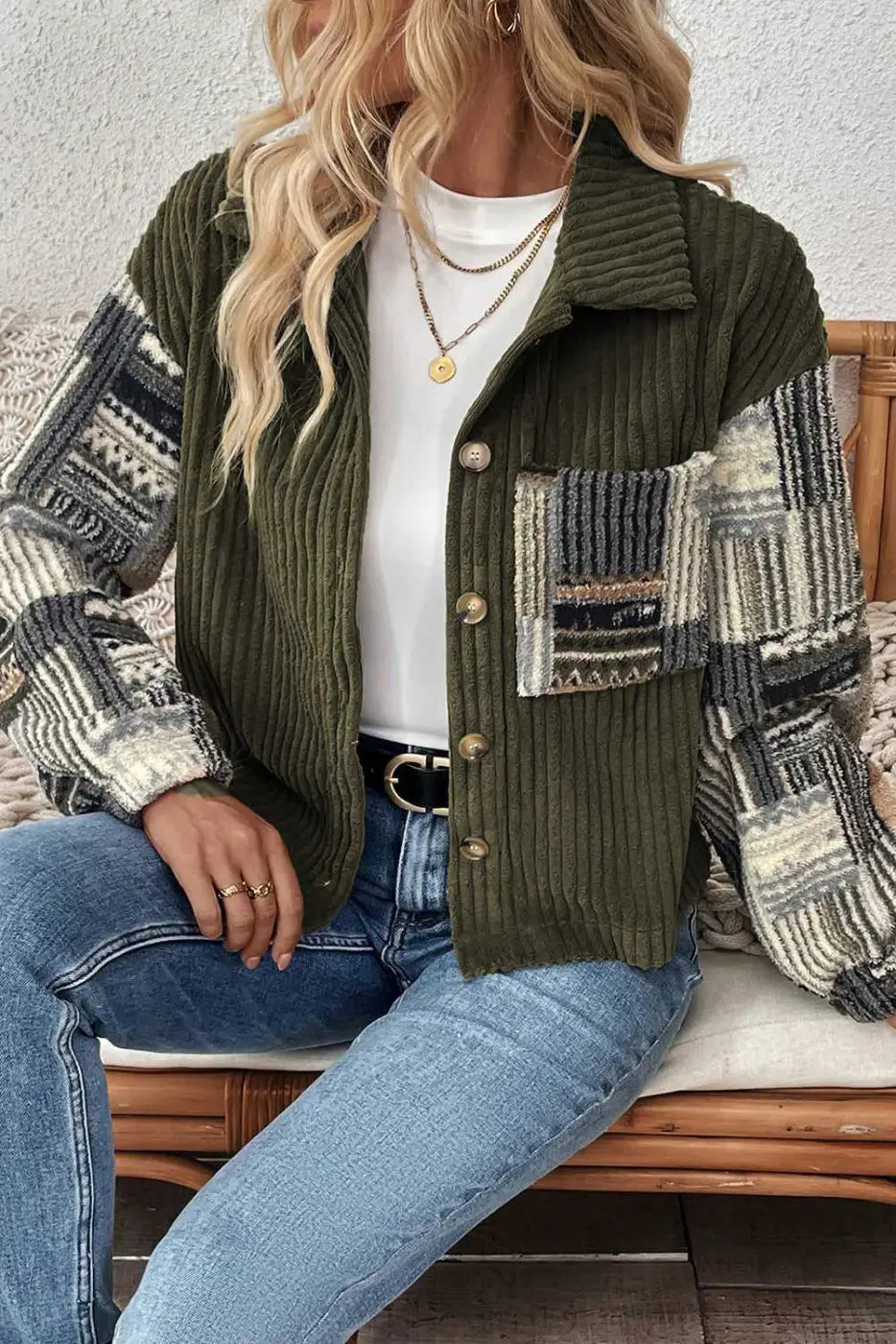 Seated model wearing Women's Green Plaid Corduroy Fleece Jacket paired with light blue jeans and white top for a cozy winter look.