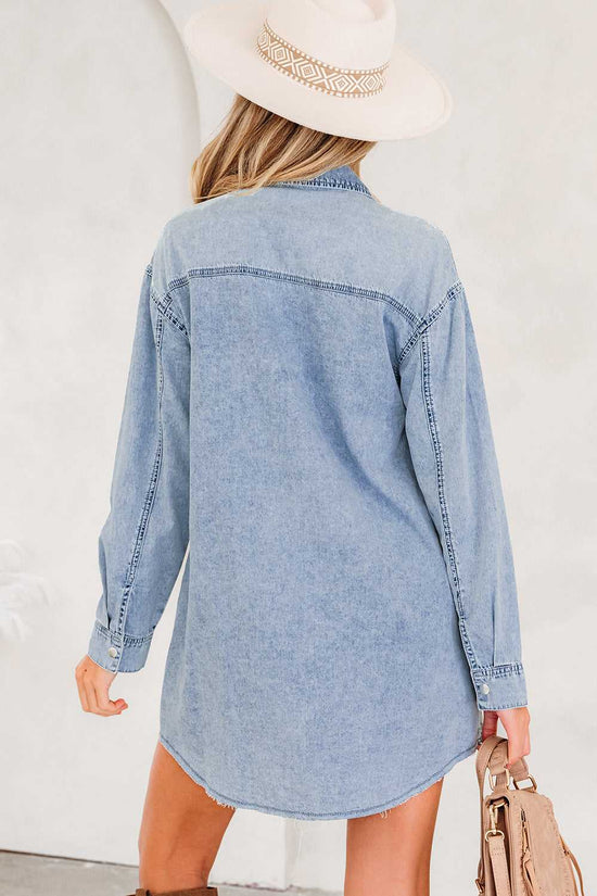 Back view of light blue oversized denim shirt dress with curved hem and relaxed fit, ideal for casual fall and autumn fashion.