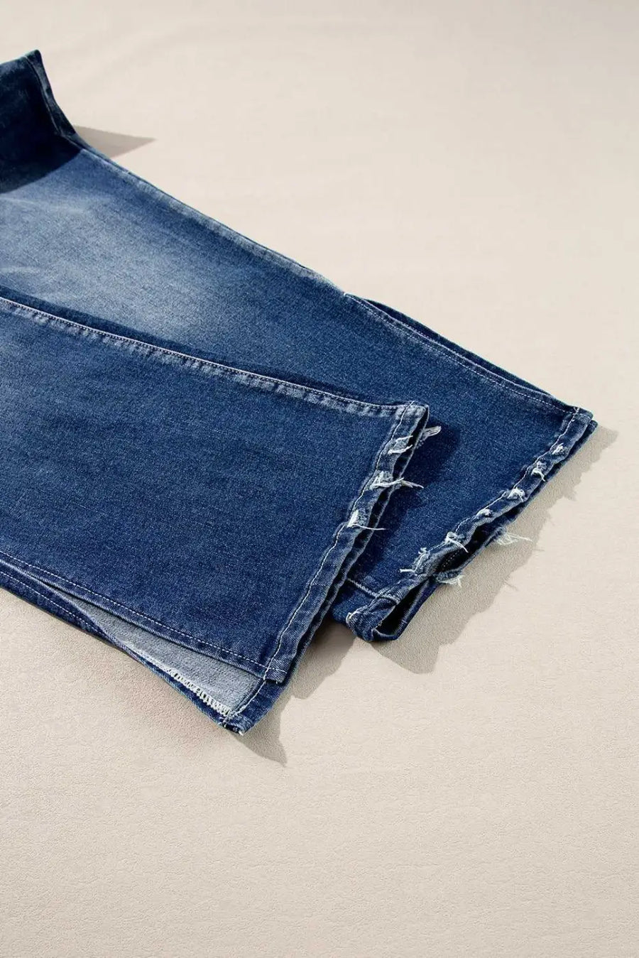 Detailed view of Dirty Blue Side‑Slit Flare Jeans – Curve hem with frayed edges and side slit, emphasizing casual plus size style.