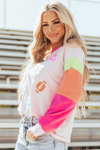 Side angle of Pink GAME DAY Graphic Top highlighting vibrant football graphics and multicolor sleeves, perfect for game day style.