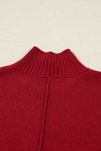 Close-up of ribbed high neckline on red knit jumper dress. Fine knit texture ideal for cozy winter wear in women’s sweater dresses.