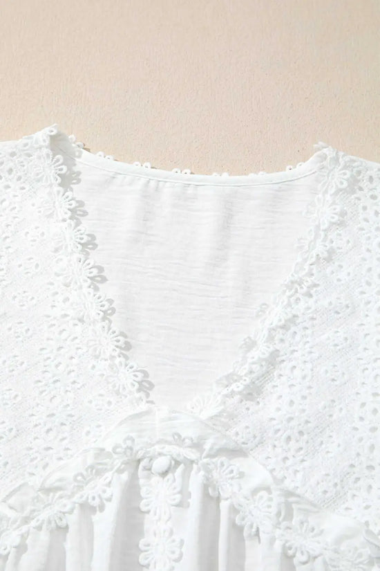 Neckline detail of the White Guipure Lace Frill Blouse with delicate floral lace and V-cut, adding a feminine touch to the solid white top.