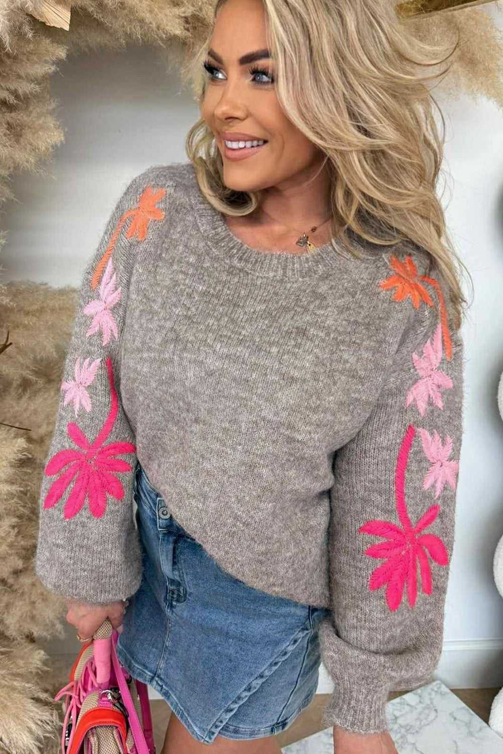 Close-up of grey Women's Floral Embroidered Sleeve Jumper with colorful floral details, perfect for fall fashion layering.