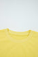 Close-up of yellow Drop Crop Set neckline with ribbed trim, highlighting quality construction and comfort-focused design.