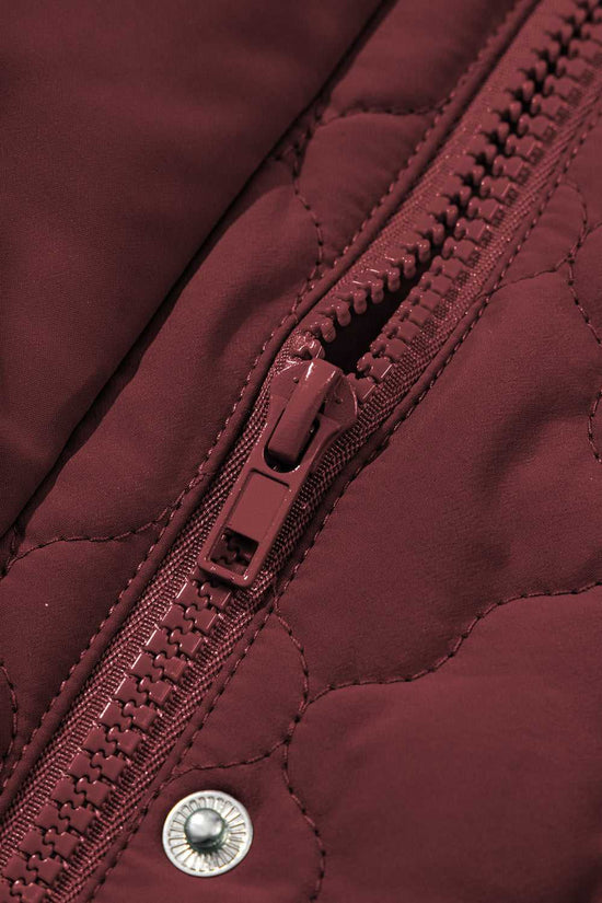 Close-up of zipper and snap button on burgundy Flower‑Quilted Winter Gilet, emphasizing secure closure and quality craftsmanship in winter vests.