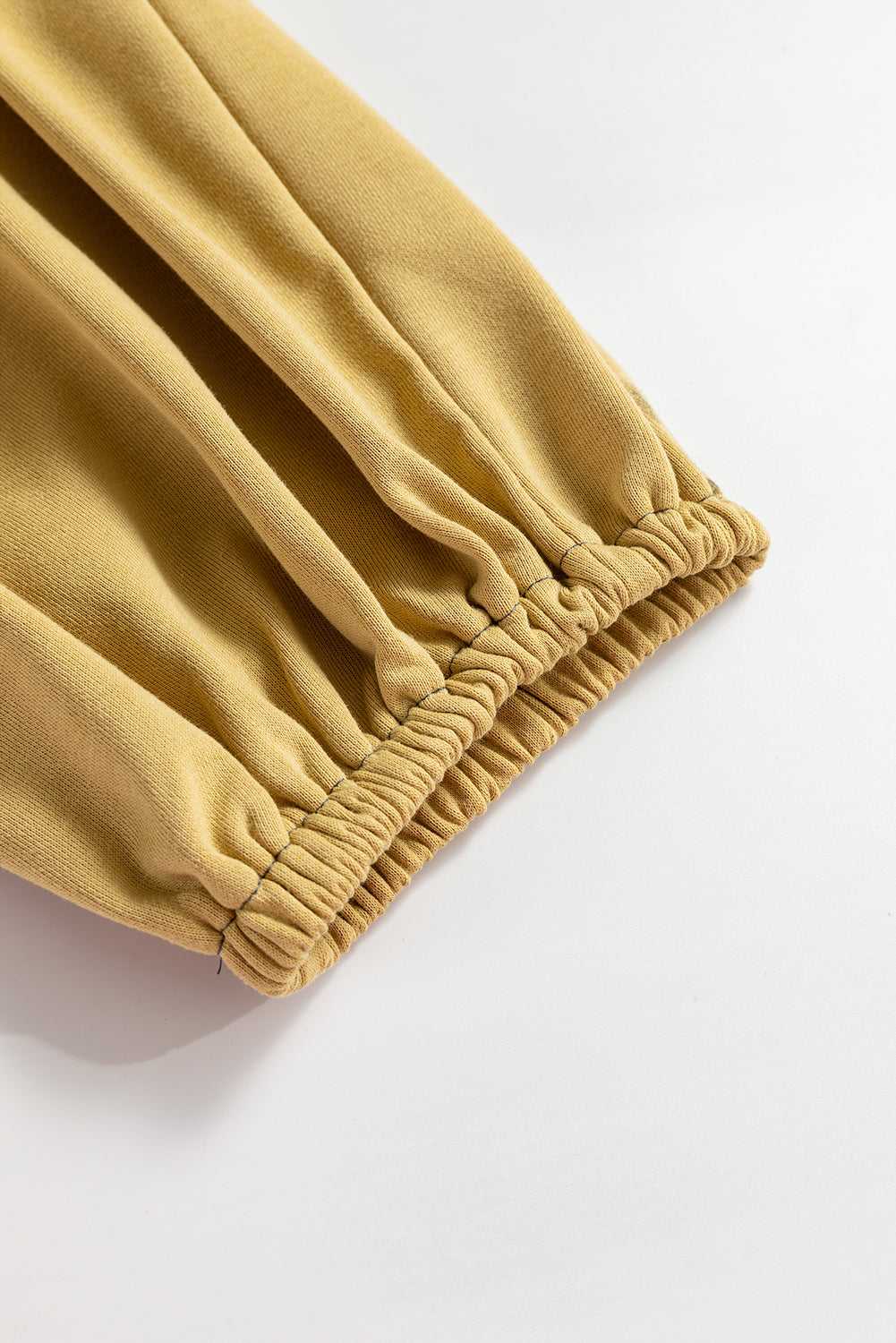 Close-up of elastic cuff on beige Terry Knit Sweatpants, showing detailed stitching and soft knit fabric for plus size comfort.