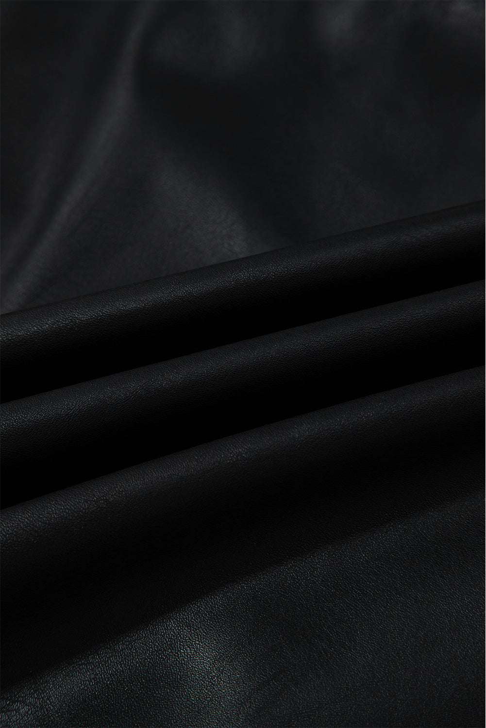Fabric texture of Black Vegan Leather Sleeveless Mini Dress, showing soft, cruelty-free PU leather ideal for fall fashion.