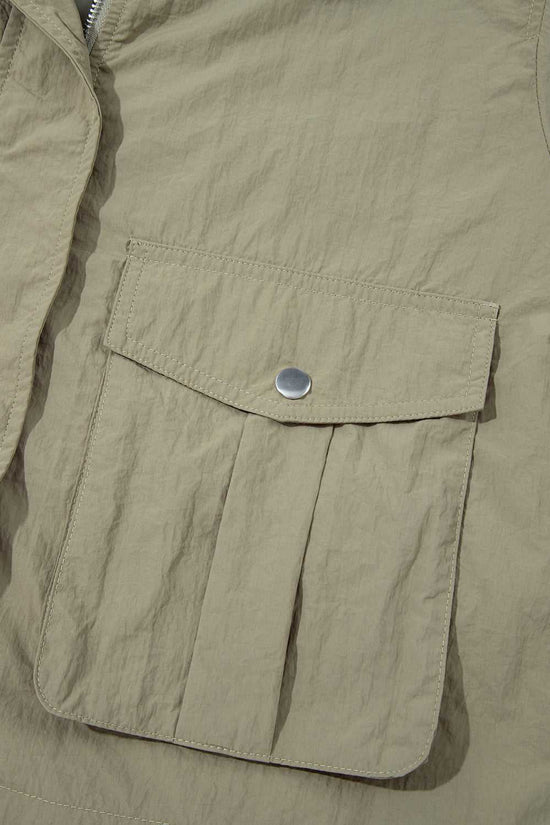 Front flap pocket with snap button on Cropped Hooded Utility Jacket, showcasing practical storage and solid color utility style.