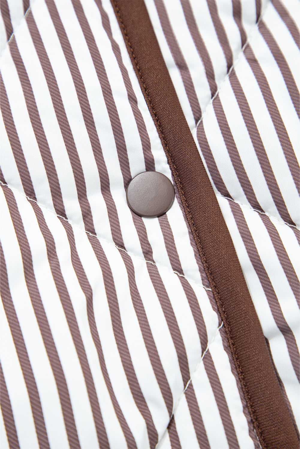 Detail of the snap button and quilted stripe fabric on the Stripe Snap Winter Vest, emphasizing quality construction and style.
