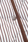 Detail of the snap button and quilted stripe fabric on the Stripe Snap Winter Vest, emphasizing quality construction and style.