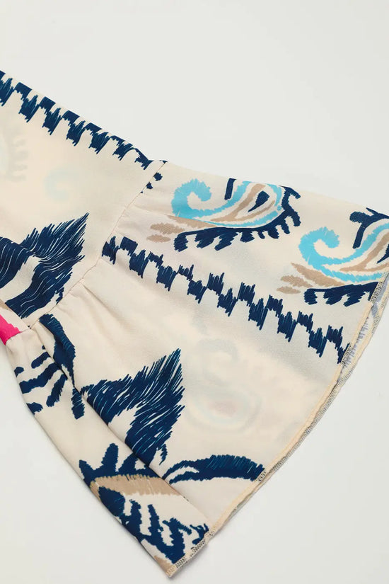 Sleeve detail of the Tribal Mini Dress, showcasing the bracelet-length bell sleeves and intricate tribal-inspired print.