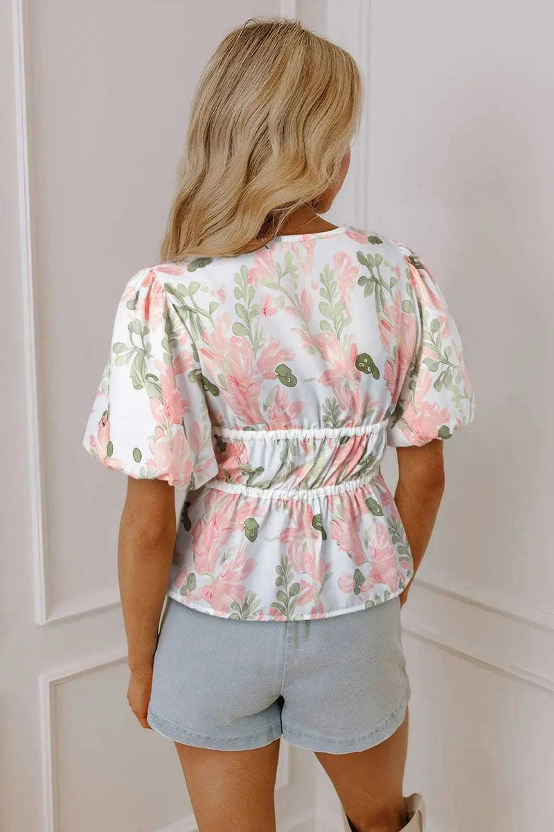 Back view of Floral Puff Sleeve Peplum Blouse showing short puff sleeve structure and peplum shape — Fashionfitz
