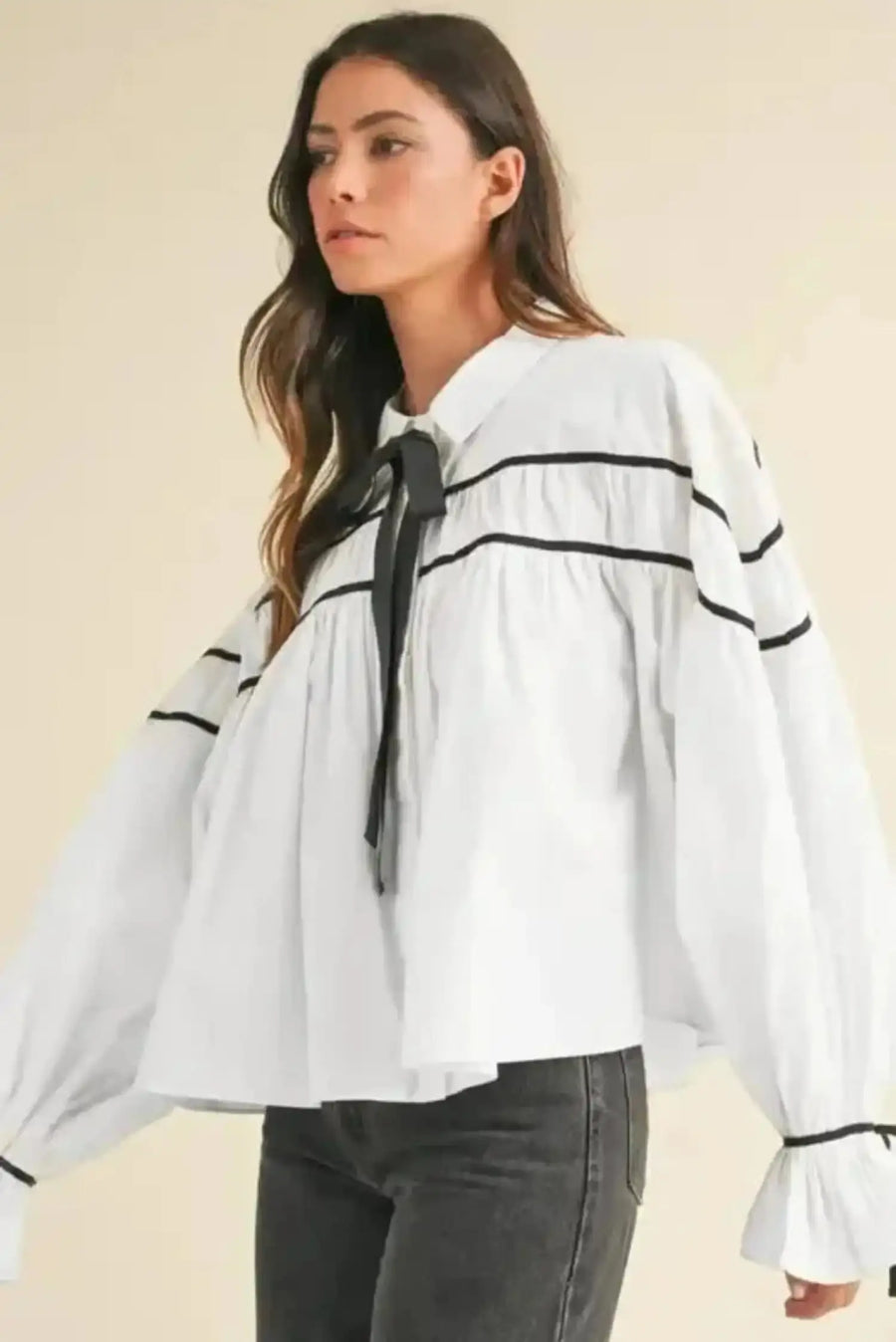 Side view of Monochrome Striped Bowtie Ruffle Blouse showing ruffled sleeve detail and black piping contrast — Fashionfitz